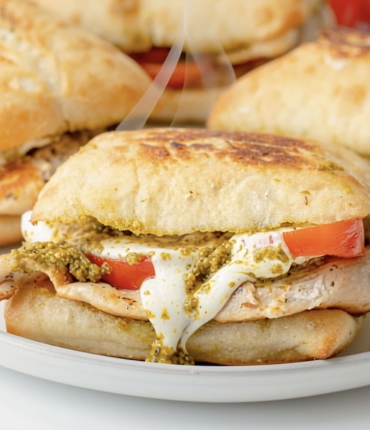 A sandwich with tomato and cheese.
