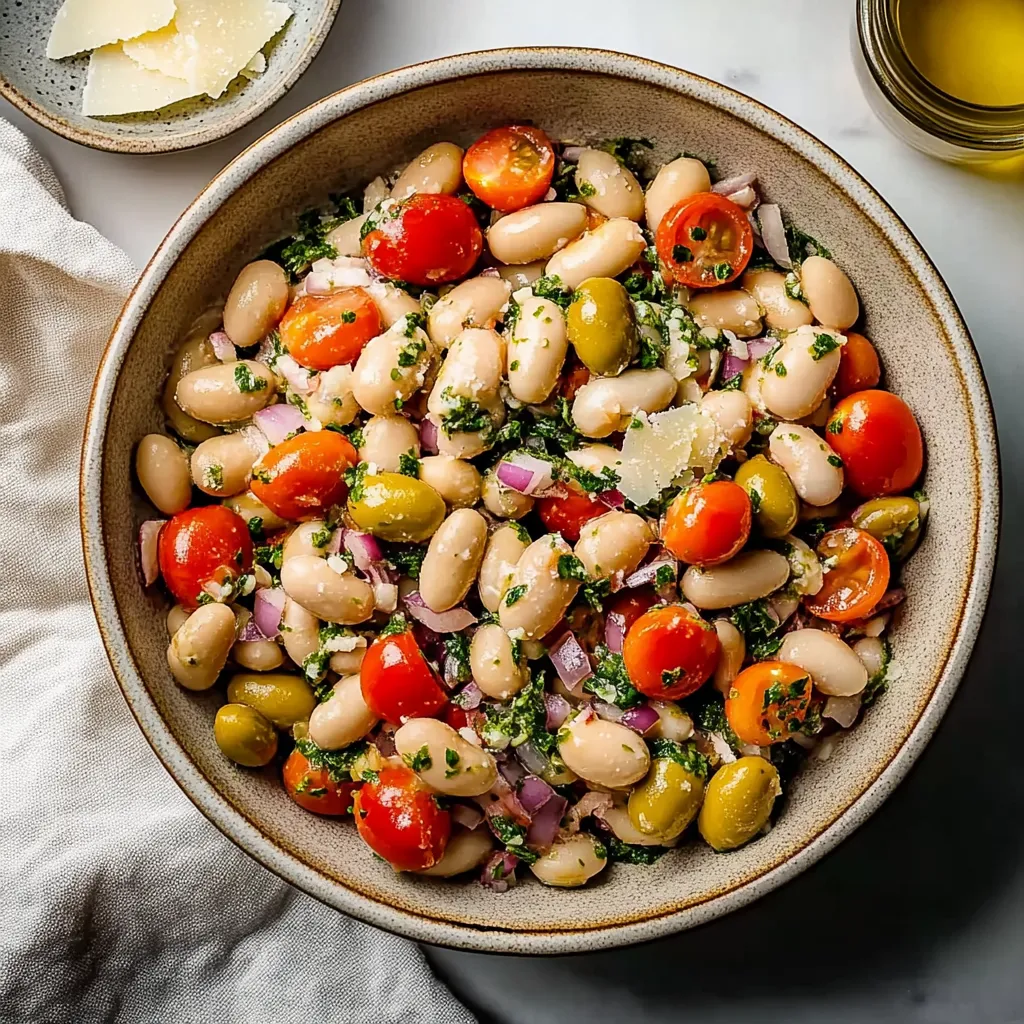 A bowl of food with tomatoes, beans, and cheese.