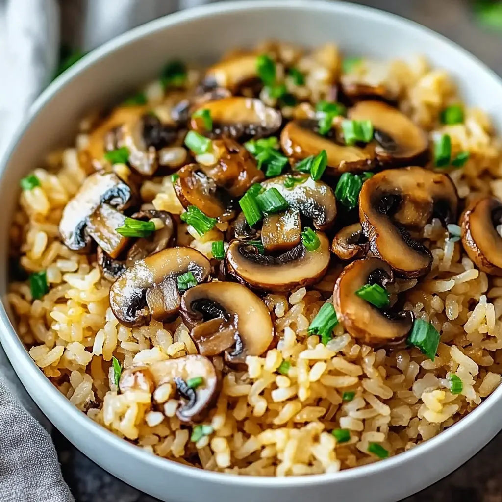A bowl of rice with mushrooms and green onions.