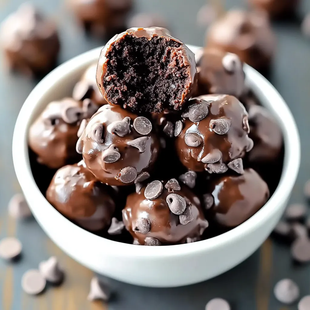 A bowl of chocolate balls with chocolate chips on top.