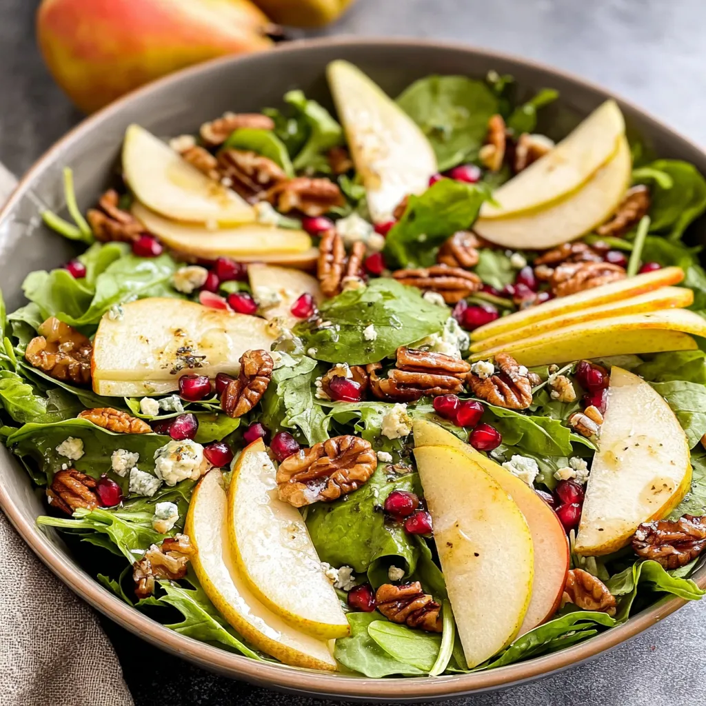 A bowl of salad with apples and walnuts.